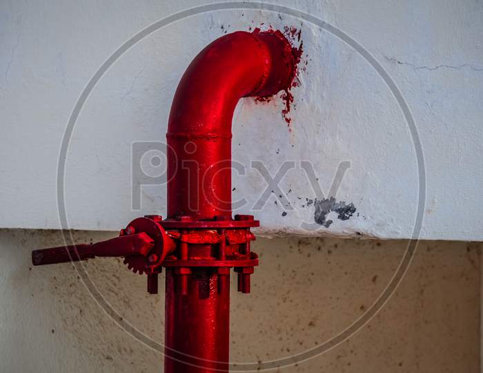 Red pipe of Fire Fighting systems is supplying water to the water sprinkler or private fire hydrants. Pipeline and valve arrangement connected from the water tank