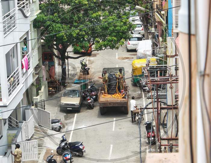 Personnel spray Disinfectants throughout the streets in Bangalore. Sanitizing residential areas to prevent the spread of Covid-19 during second wave lockdown