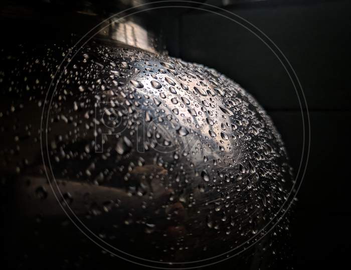 Water Droplets Settle On The Stainless Steel Pot Lid.