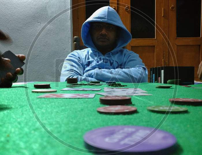 Men Dealer Or Croupier Shuffles Poker Cards In A Casino On The Background Of A Table, Chips,. Concept Of Poker Game, Game Business, India.