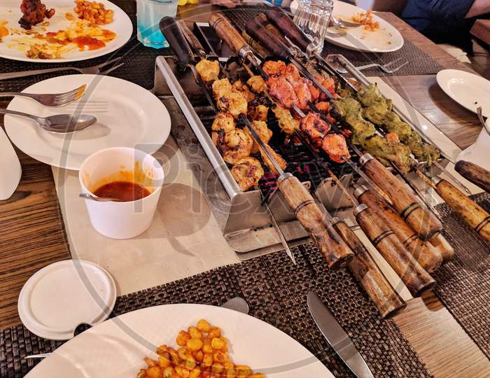 Spicy Marinated Chicken Wings, Prawns, Kabab And Legs Grilling On A Summer Barbecue In A Close Up View, Marinated Shashlik Preparing On A Barbecue Grill Over Charcoal. Roast Beef Kebabs On Bbq Grill. India.