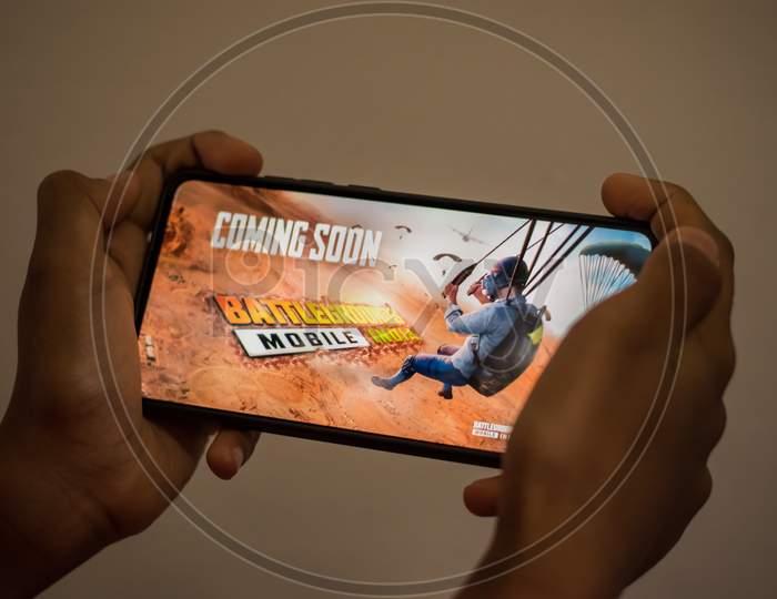 Kerala , India - 16 May 2021 : Photo Of A Player Hand Holding Smartphone With Battlegrounds Mobile India Trailer Previously Known As Playerunknown'S Battlegrounds Also Known As Pubg India.