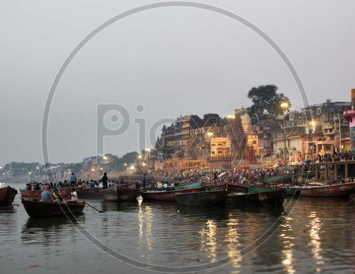 Varanasi, India - November 01, 2016: Boats At River Ganga Ghat People At Holy Ghats Among Ancient Hindu Temples In Early Morning In Varanasi Or Ancient Banaras City India Assi Ghat Aarti Ceremony At Ganga River Evening At Banaras Ghat Ancient Wooden Boats