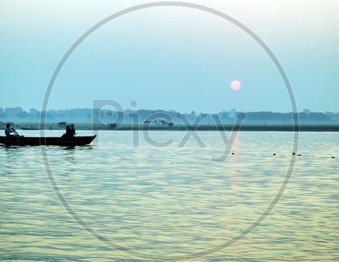 Pilgrims Floating By Boat Of The Sacred Ganges River. Sunrise In Varanasi. Uttar Pradesh, India.