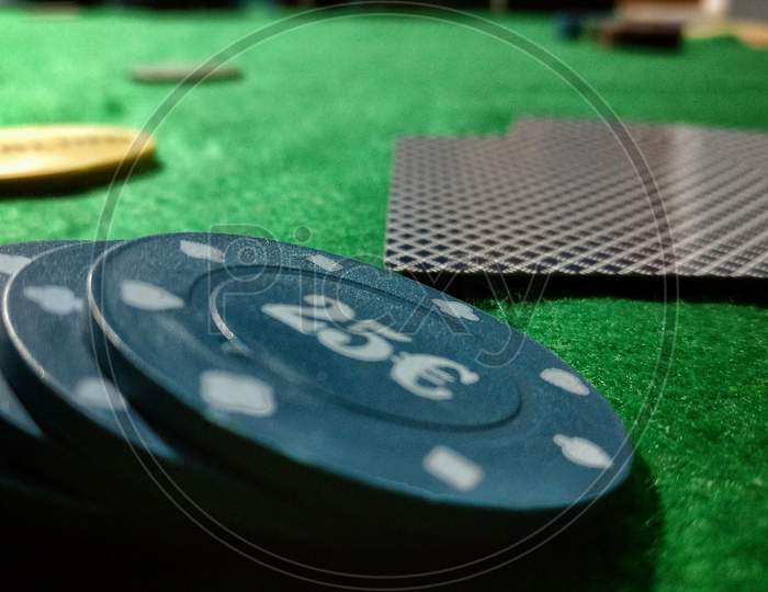 Black Poker Chips Lie On A Bright Green Canvas Concept Of Gambling And Casino