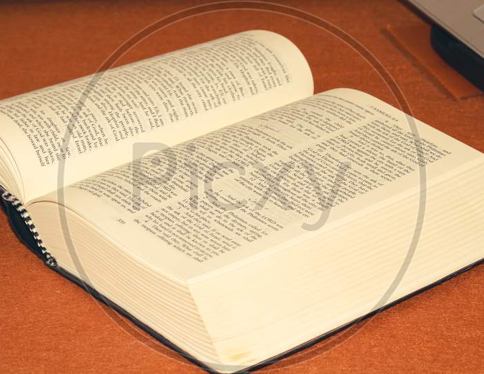 Open Holy Bible Book on Table