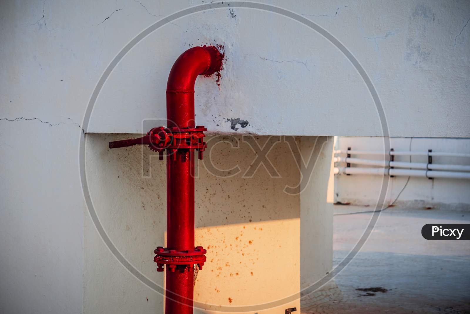 Red pipe of Fire Fighting systems is supplying water to the water sprinkler or private fire hydrants. Pipeline and valve arrangement connected from the water tank