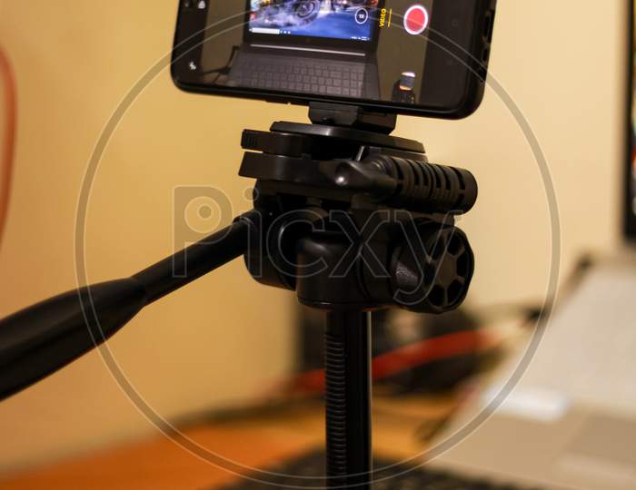 Smart Phone On Tripod Shooting Object At Indoor Photo Studio