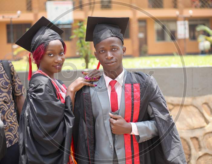 boy friend girl friend graduate on their graduation in ties and suites day