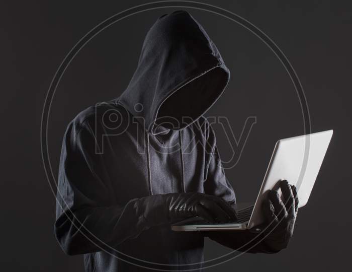 side view male hacker with gloves laptop