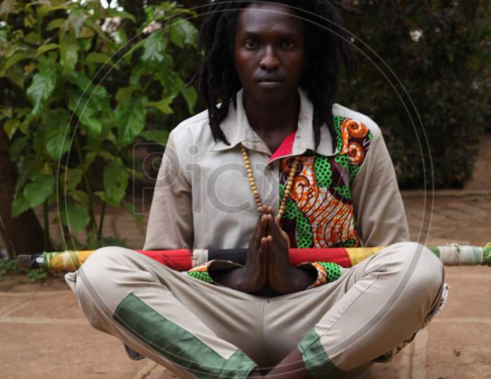 Image of Black African man raster man meditation on the floor in the ...