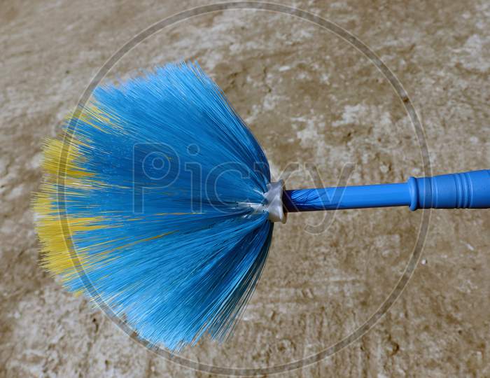 Blue And Yellow Colored Broom Closeup