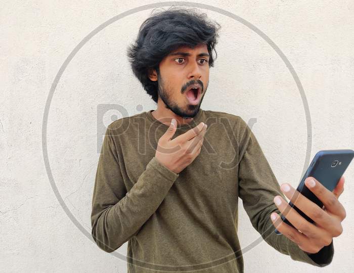 Shocking Reaction Of Young Tamil Man Seeing His Smart Phone. Wearing Full Sleeves. White Background