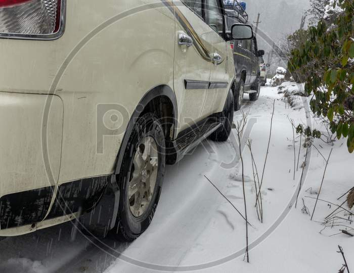 A White Car Tyre Standing On Winter Roads Covered With Snow.
