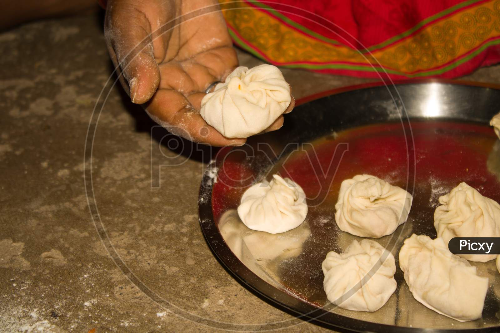 Closeup Of Indian Woman Hands Making Purse Shape Dumpling Momo ( Cooking Process )