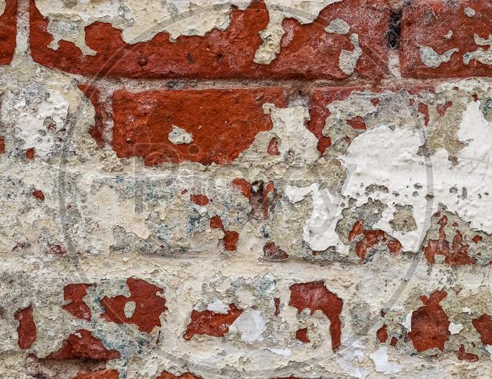 Old Vintage Weathered Brick Wall With Peeling Paint.