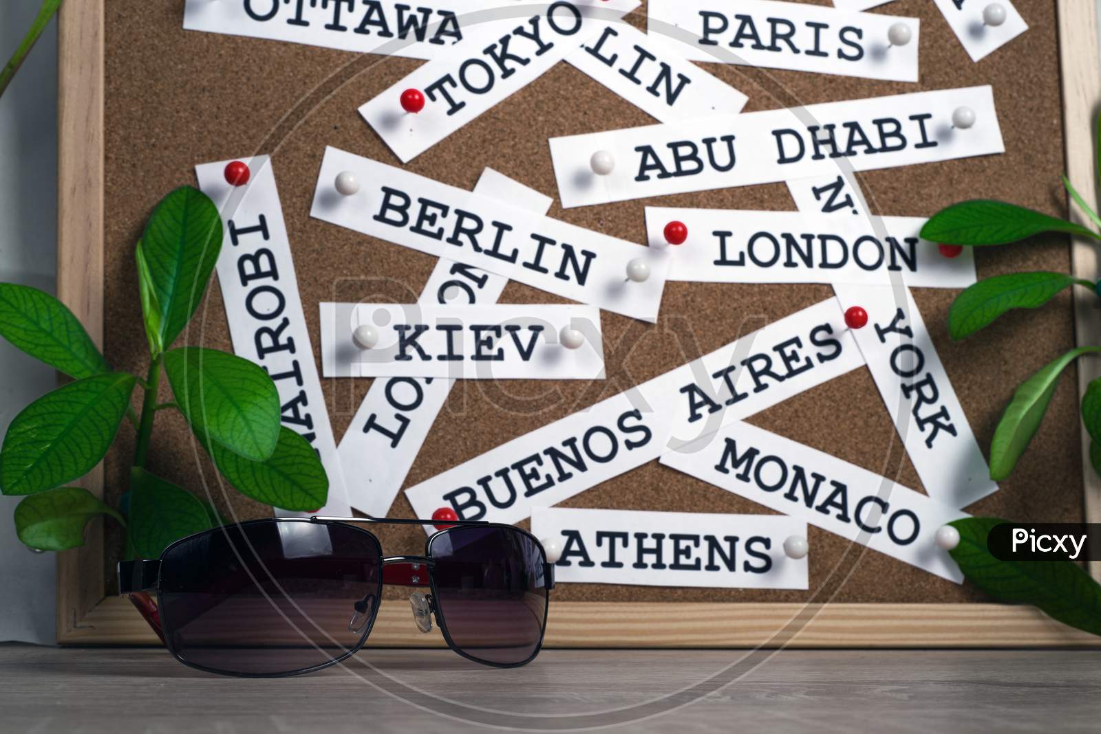 background created from the names of the capitals of the countries of the world on a cork surface