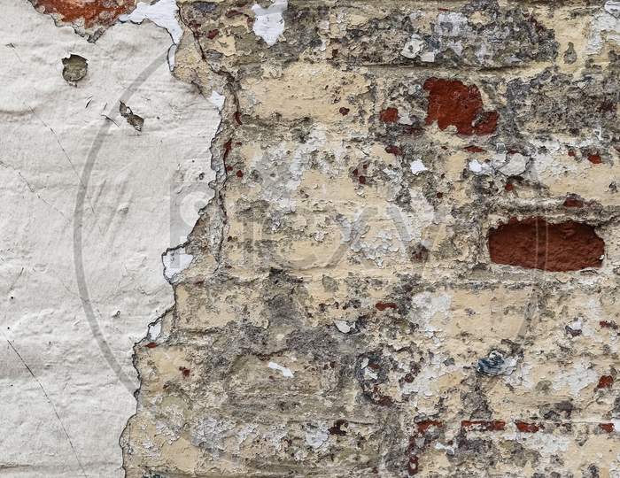 Old Vintage Weathered Brick Wall With Peeling Paint.