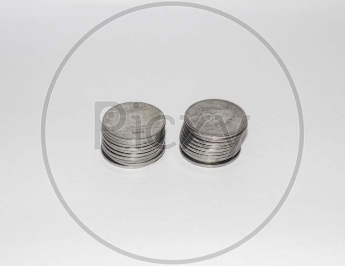 Indian currency coins on white background