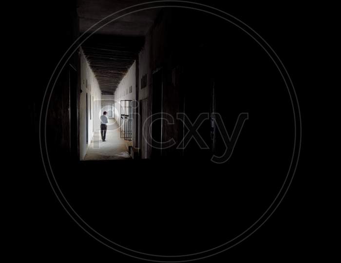 A Man Walking In Empty Walkway In An Old School Corridor In An Indian Village Bihar