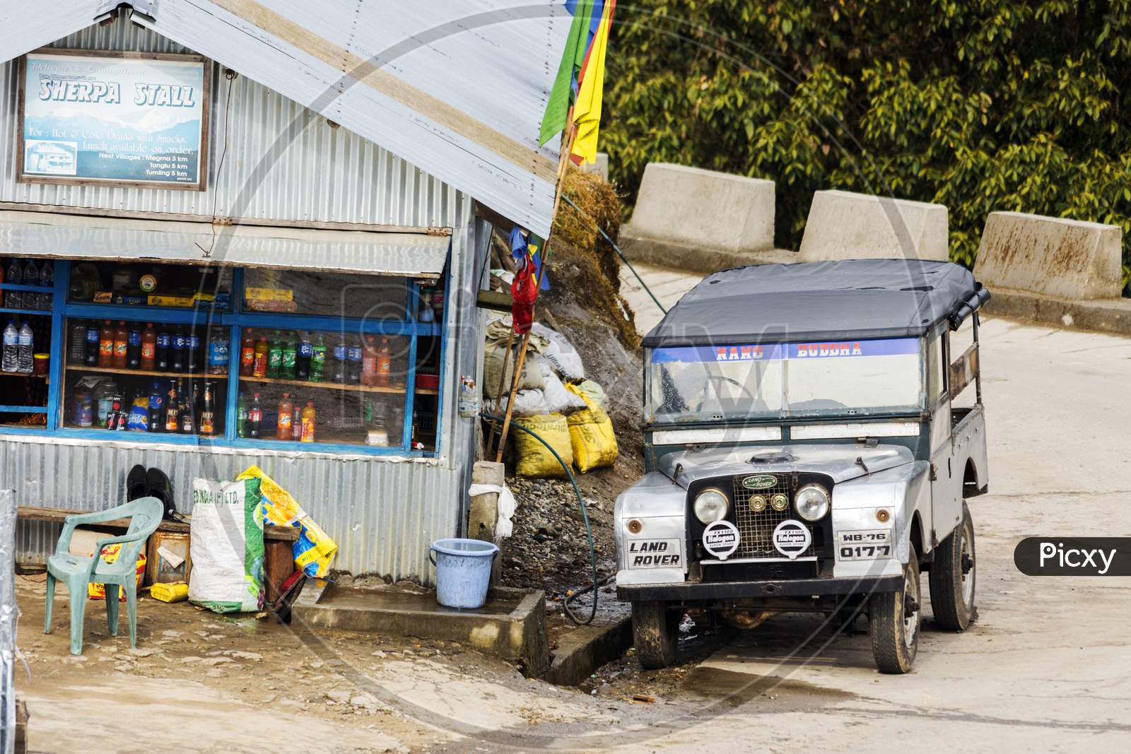 A Old Land Rover Car Parked Beside A Road Side Food Stall At Megma, West Bengal, India.