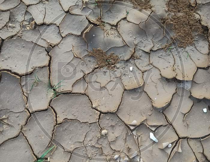 Dry cracked land due to the scarcity of water in summer.