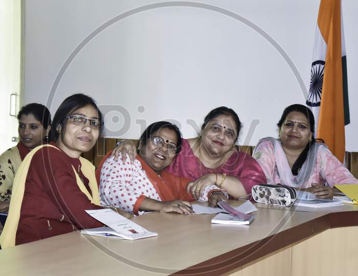 Rear view of a group of women attending seminar in conference hall. Lifelong learning