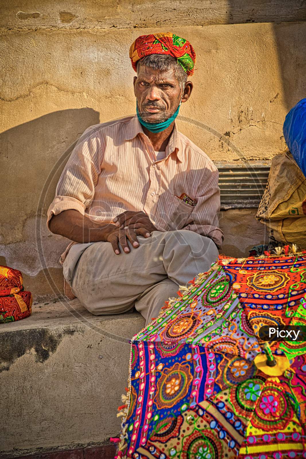 A street vendor at Amer fort selling colourful turbans.