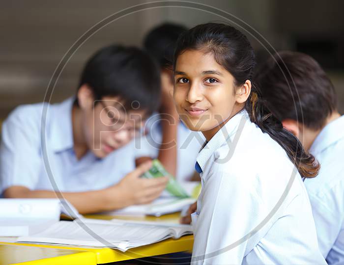 Student in government with school  uniforms sitting on chair, studying reading books indoors classroom. Portrait of teenagers