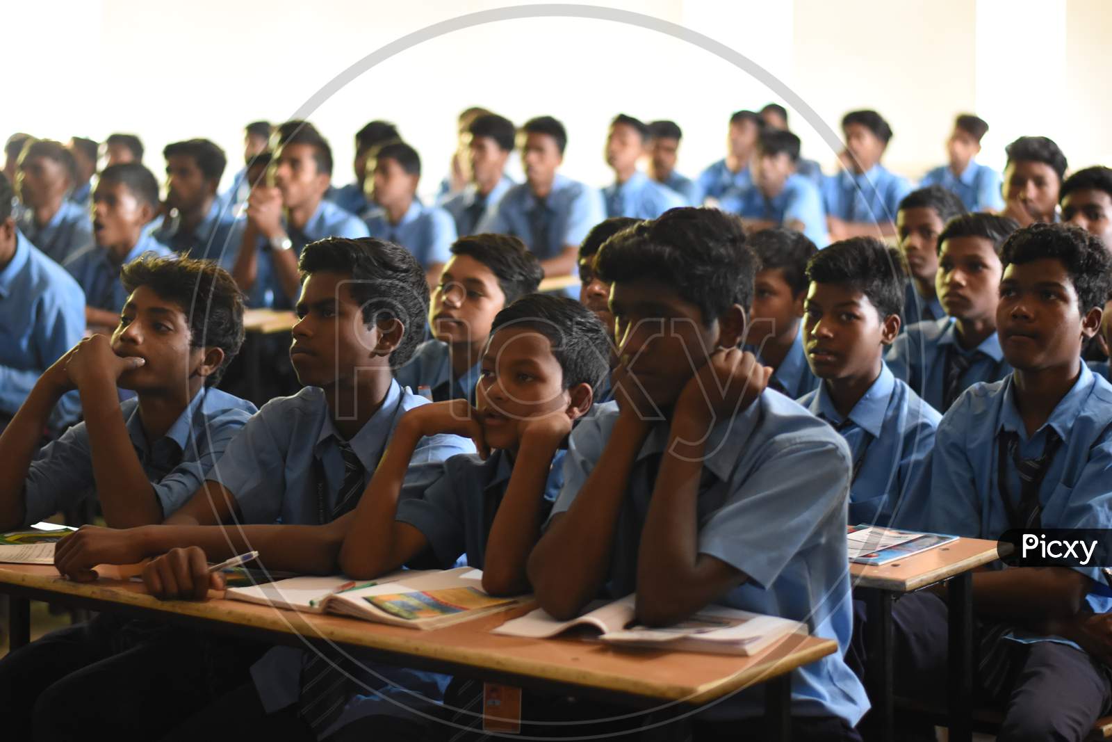 Closeup image of Group of unidentified Indian  students of government school sitting inside the class room  and enjoying class activity