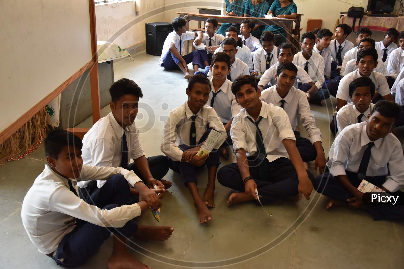 Group of unidentified Indian  students of government school inside the class  and enjoying class activity