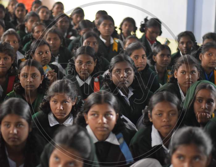 Group of unidentified Indian girl students of government school inside the class room sitting on floor and enjoying class activity