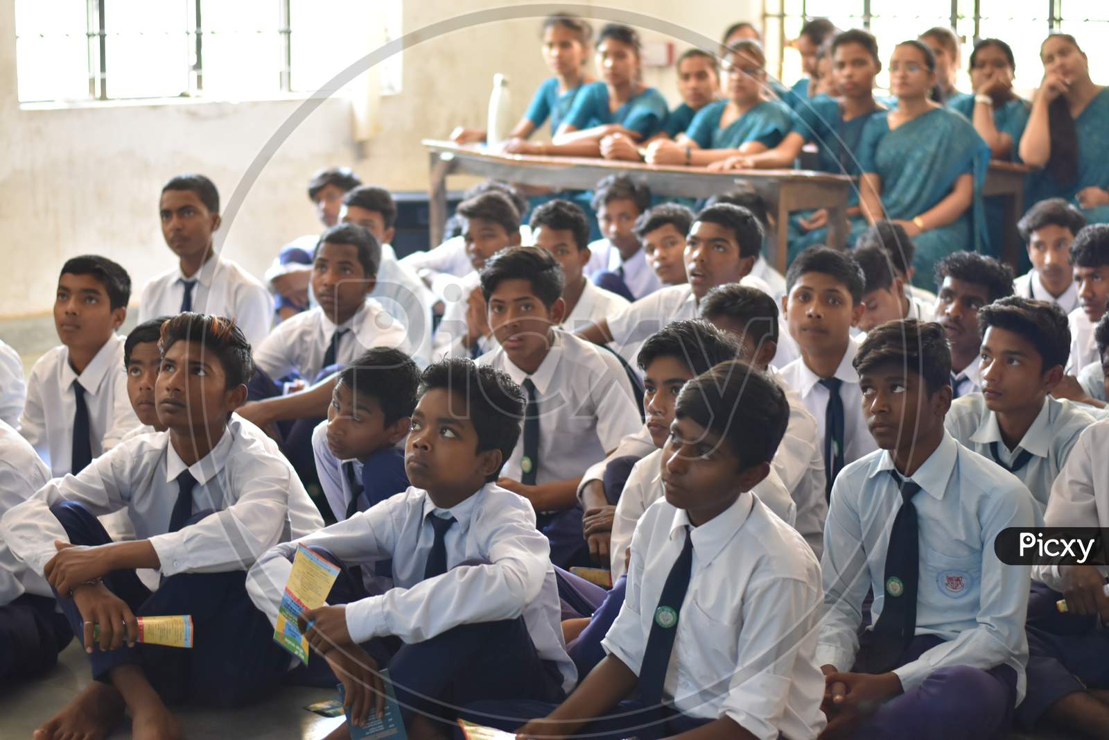 Group of unidentified Indian students of government school inside the class  and enjoying class activity