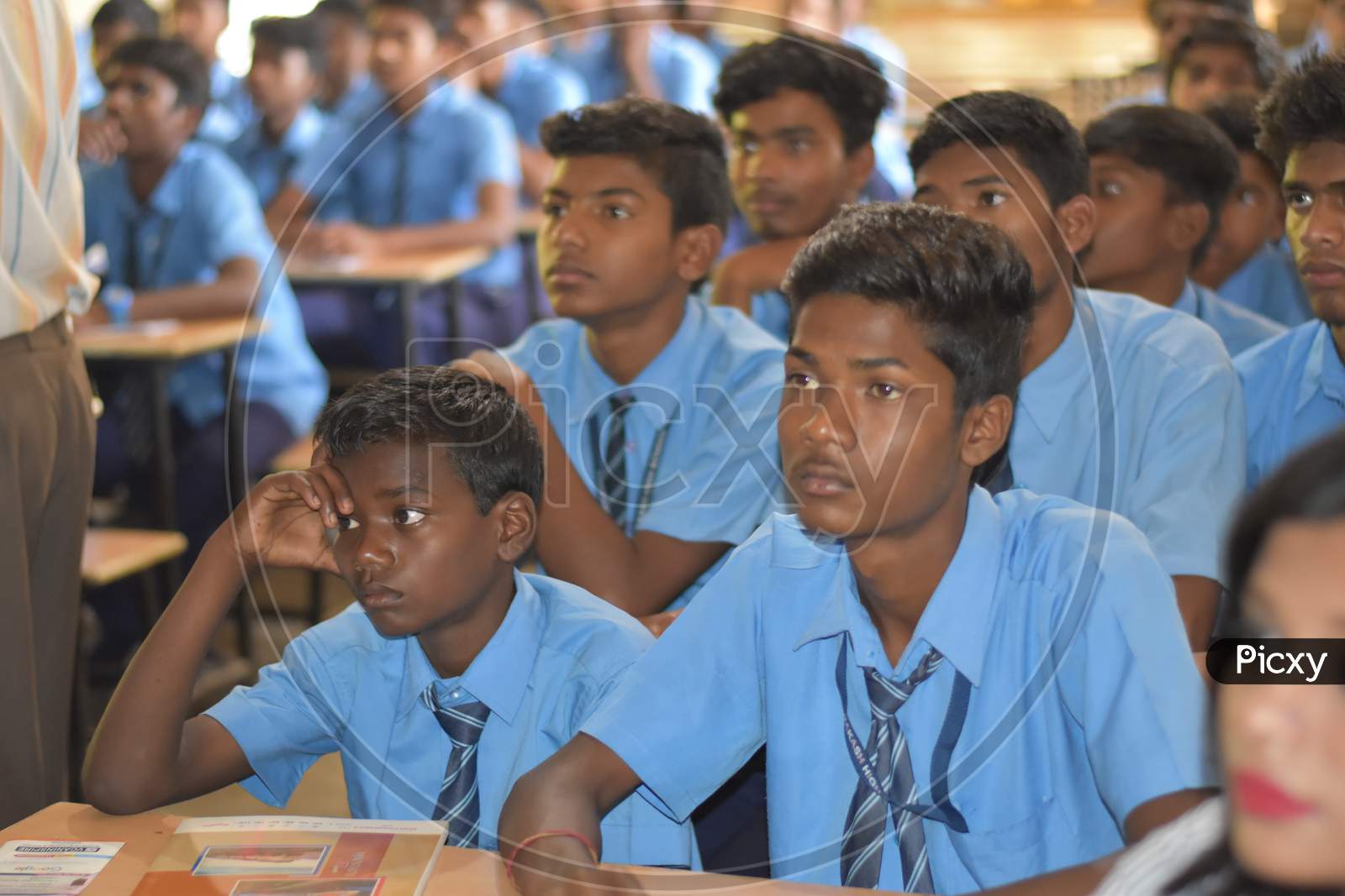 Closeup image of Group of unidentified Indian girl students of government school sitting inside the class room  and enjoying class activity