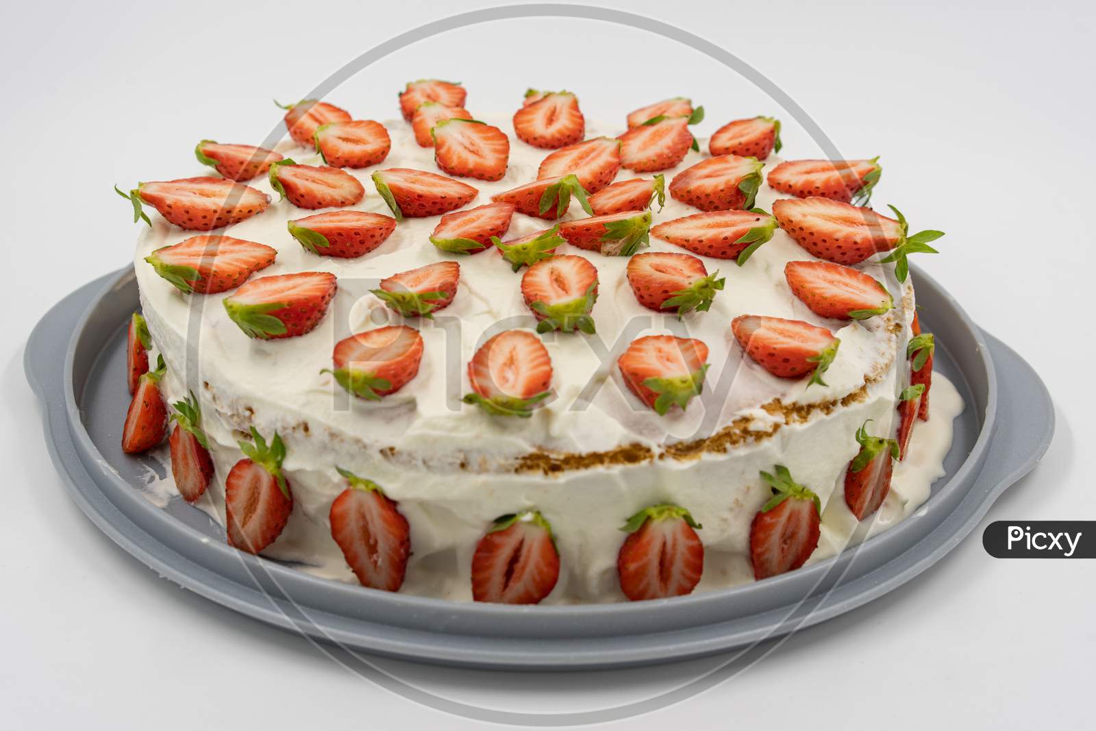 Isolated Strawberry Cheesecake On White Background Decorates With With Fresh Half Strawberries.