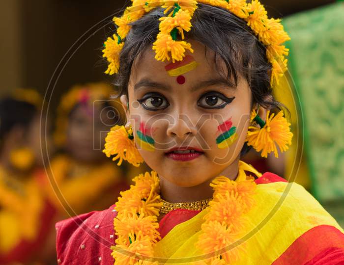 A cute little girl in a colorful dress to celebrate Holi, the festival of colors.