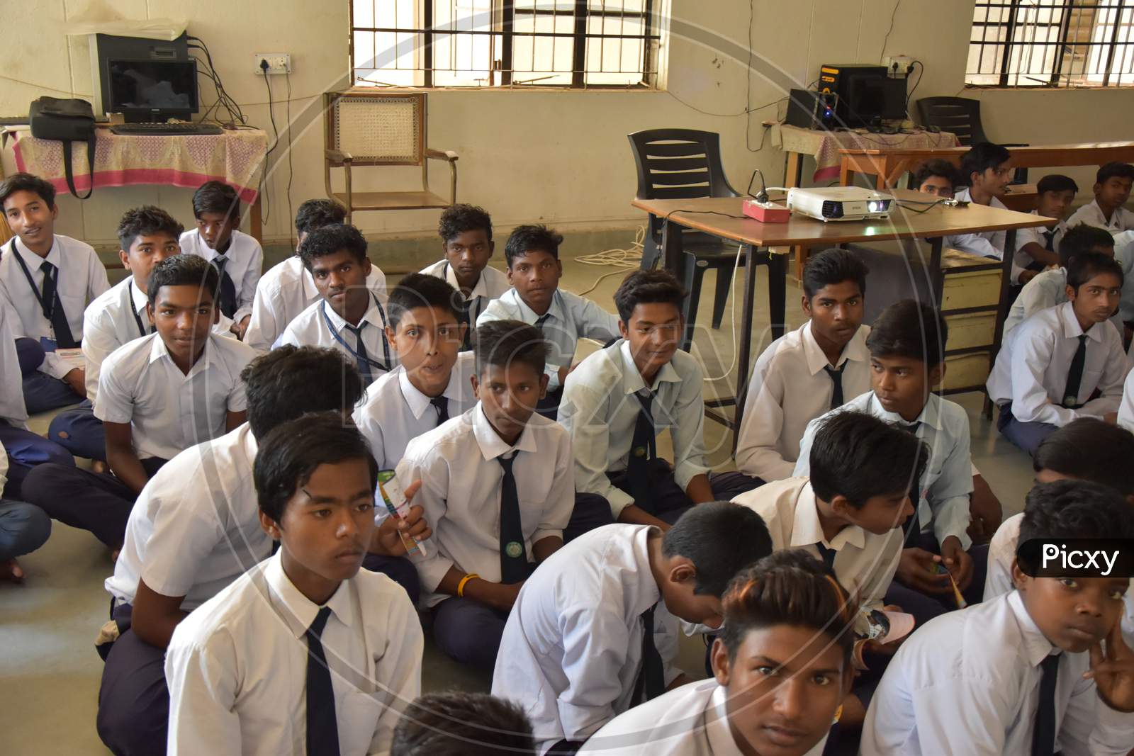 Group of unidentified Indian  students of government school inside the class room and enjoying class activity