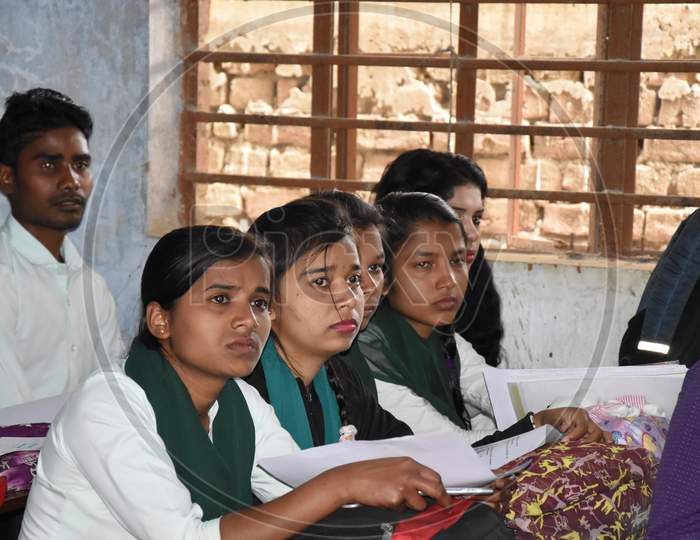 Unidentified group of  indian engineering Students study with university professor in modern school classroom.