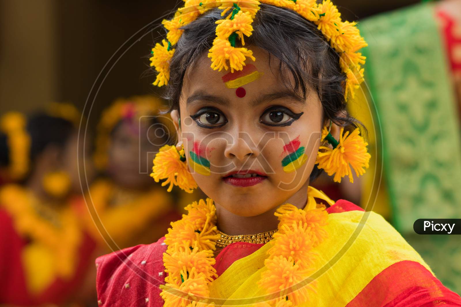 A cute little girl in a colorful dress to celebrate Holi, the festival of colors.