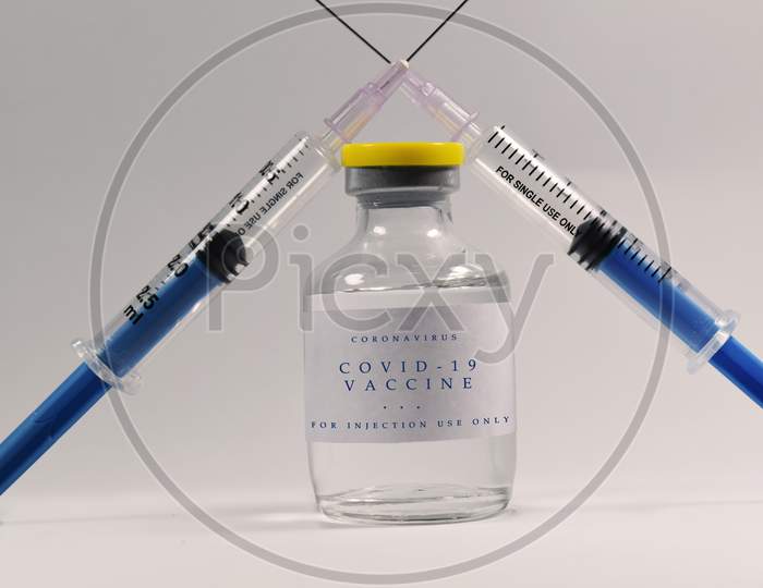 Corona virus vaccine in focus with syringe