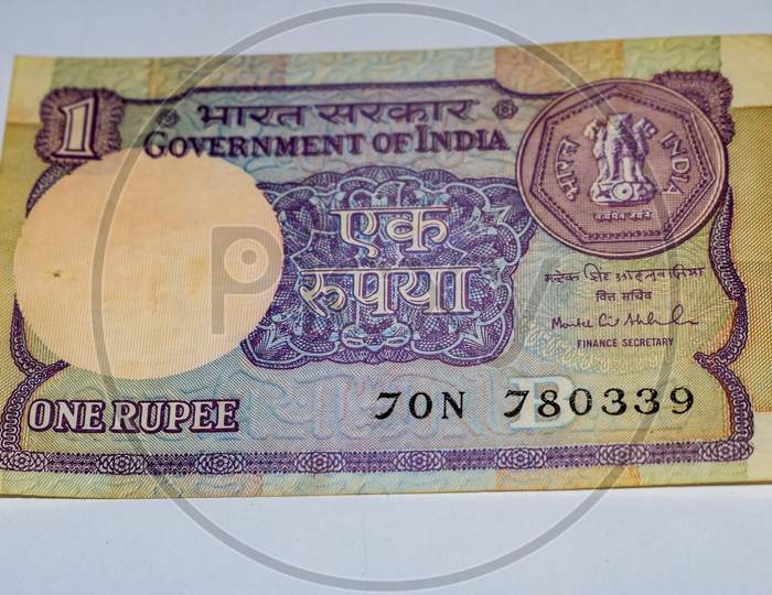 Indian One Rupee Currency Note On White Background, Government Of India One Rupee Old Banknote Indian Currency, Old Indian Currency Note On The Table
