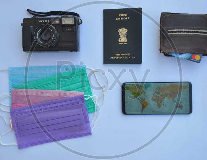 Mandi, Himachal Pradesh, India - 04 24 2021: High angle view of important accessories of travel isolated over white background, Concept of traveling during coronavirus pandemic (Covid-19 crisis)