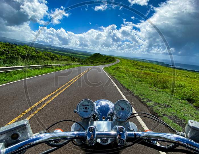 Vertical Shot Of A Motorbike On The Road With The Beautiful View Of Mountains On Kauai, Hawaii