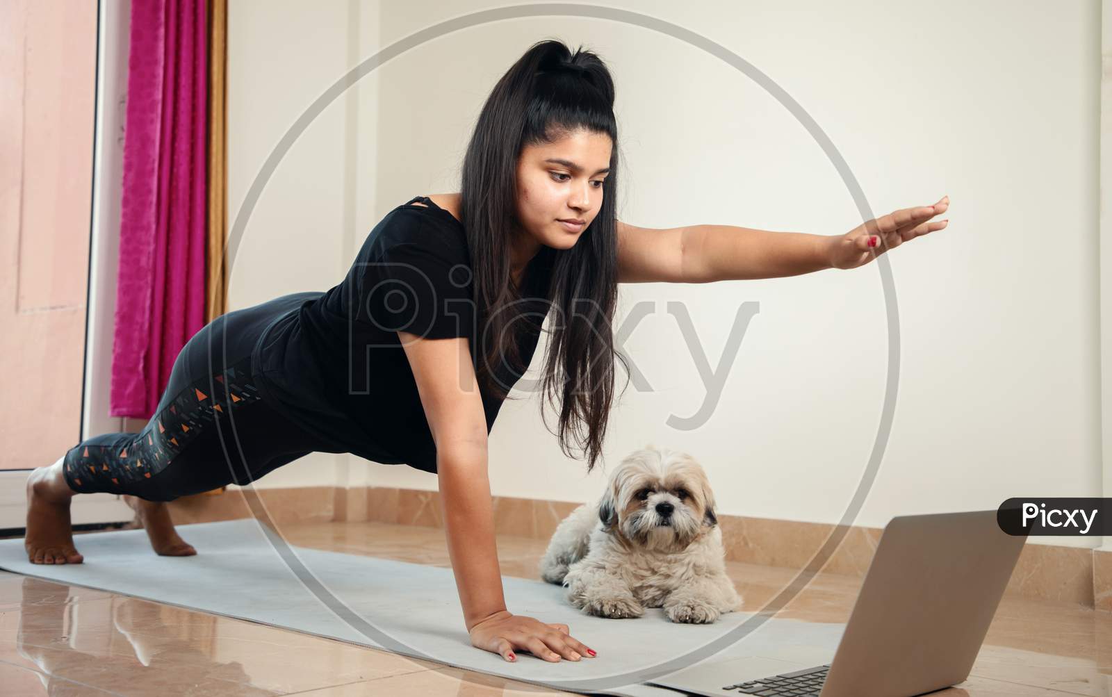 Young Millennial Girl Learning Yoga From Home During Online Class By Looking Laptop - Concept Of E-Learning, New Normal, Home Workout Due To Coronavirus Covid-19 Lockdown