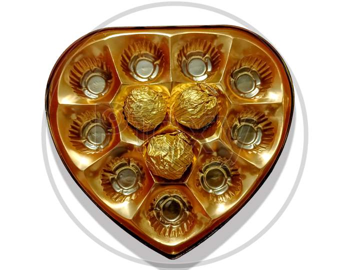 Close-Up Of Delicious Chocolates Kept In A Beautiful Love Shape Golden Tray