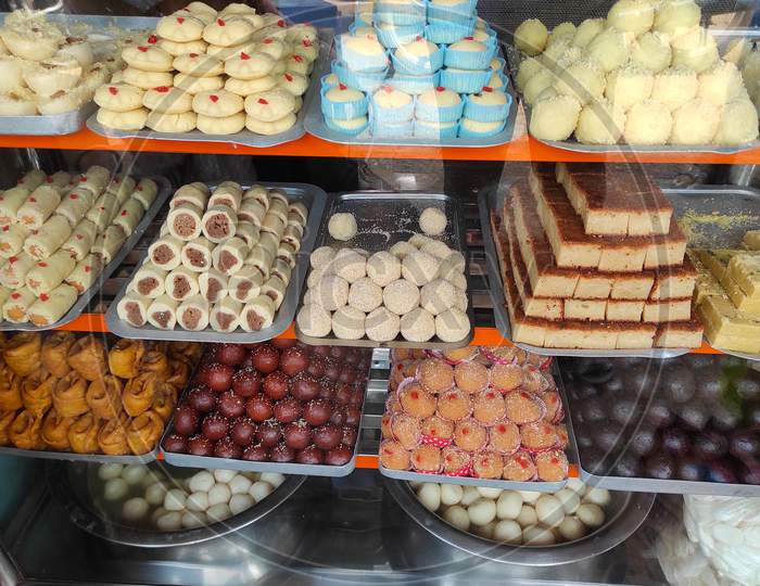 Various Types Of Delicious Sweets Of Bengal Are Arranged In A Showcase In A Sweet Shop In Kolkata