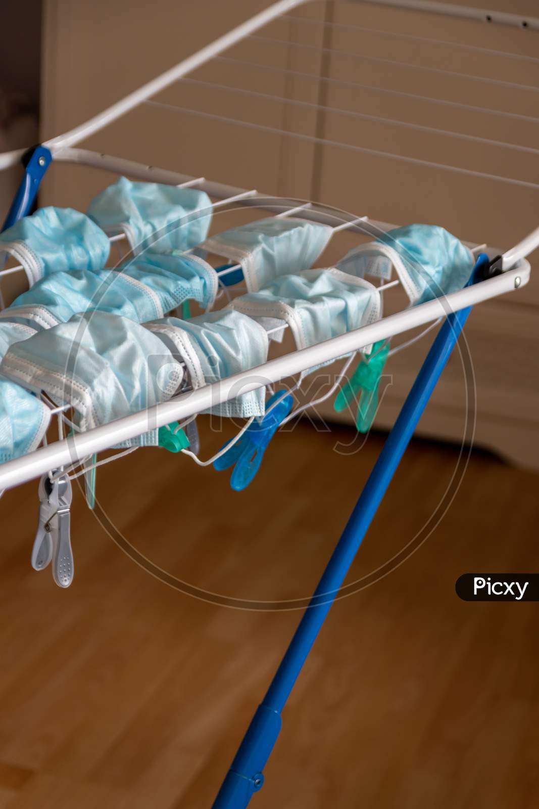 Image of Washed surgical masks hanging on a clothes drying rack after