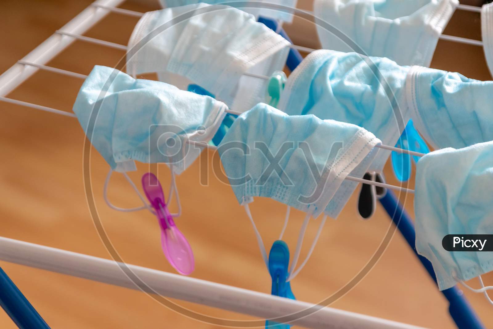 Image of Washed surgical masks hanging on a clothes drying rack after