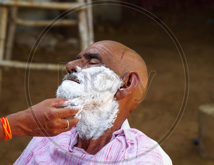 Indian Barber Working On The Village Streets In A Sunny Day