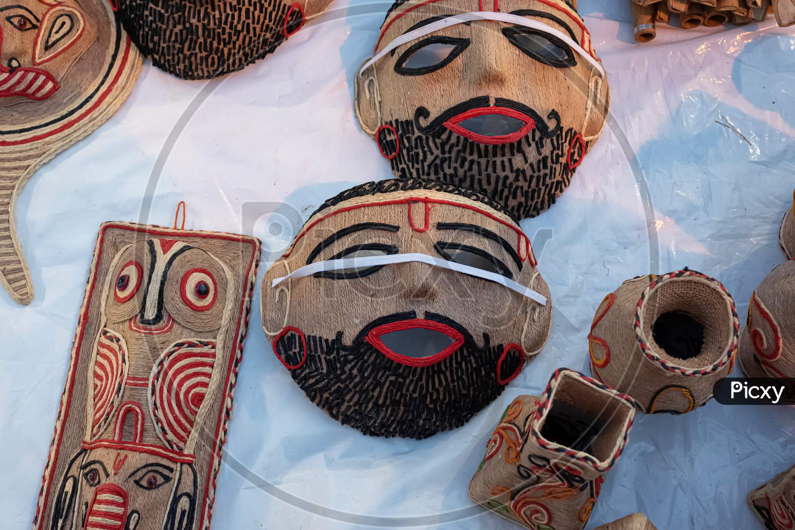 Beautiful Handmade Mask Made By Jute Is Displayed In A Shop For Sale In Blurred Background. Indian Handicraft